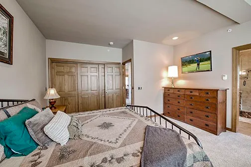 a bathroom with a granite countertop sink a mirror and shower