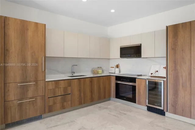 a kitchen with stainless steel appliances granite countertop a refrigerator and a sink