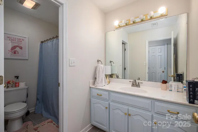 a bathroom with a sink toilet and a mirror