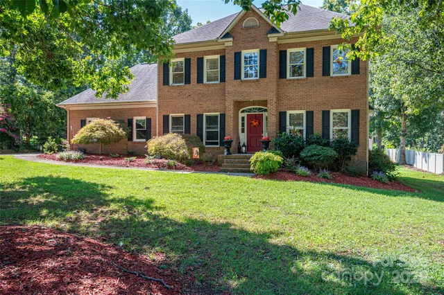 a front view of house with yard and green space