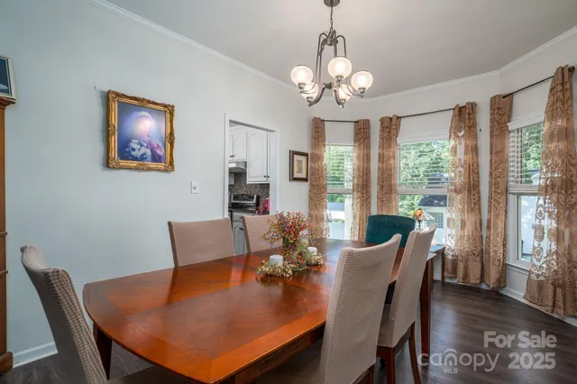 a view of a dining room with furniture wooden floor and chandelier