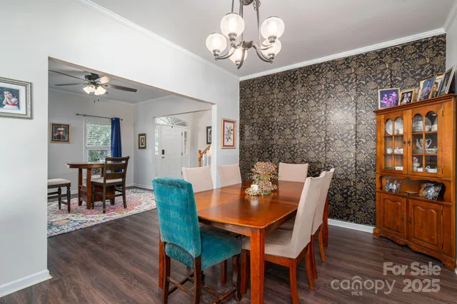 a view of a dining room with furniture wooden floor and chandelier