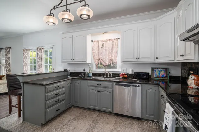 a kitchen with cabinets appliances and a window