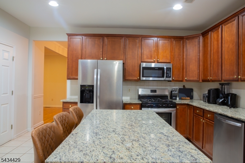 4 Lewis Hollow Road Randolph, NJ 07945 - Photo 6 of 10 a kitchen with stainless steel appliances granite countertop a refrigerator stove top oven a sink and dishwasher