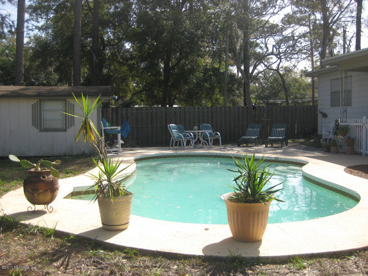 325 Jackson Road Jacksonville, FL 32225 - Photo 1 of 26 a view of swimming pool with outdoor seating and plants