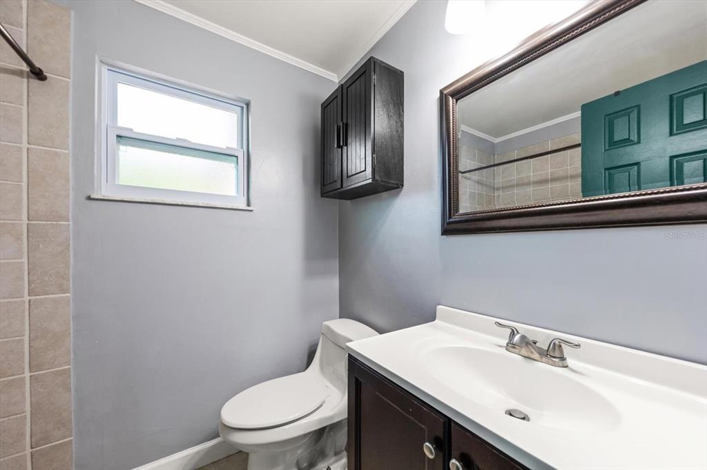 611 11th Street Northwest Largo, FL 33770 - Photo 19 of 37 a bathroom with a sink a toilet and mirror