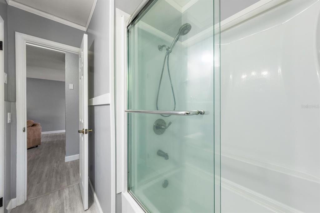 611 11th Street Northwest Largo, FL 33770 - Photo 22 of 37 a bathroom with a glass shower door