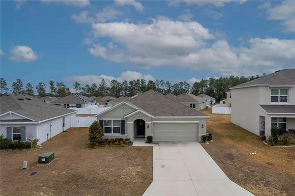 a aerial view of a house next to a yard