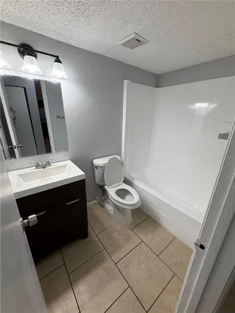a bathroom with a toilet and a bathtub