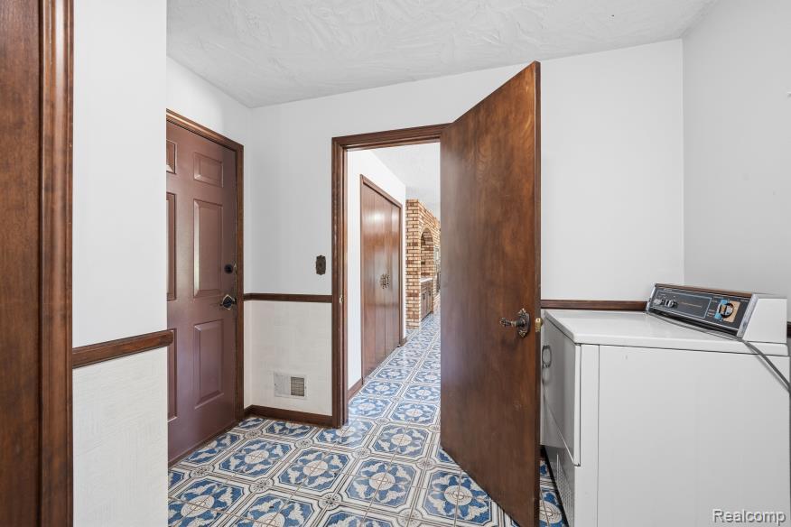 7020 Rattalee Lake Road Clarkston, MI 48348 - Photo 21 of 47 Tiled flooring featuring a blue and white geometric pattern extends throughout this area