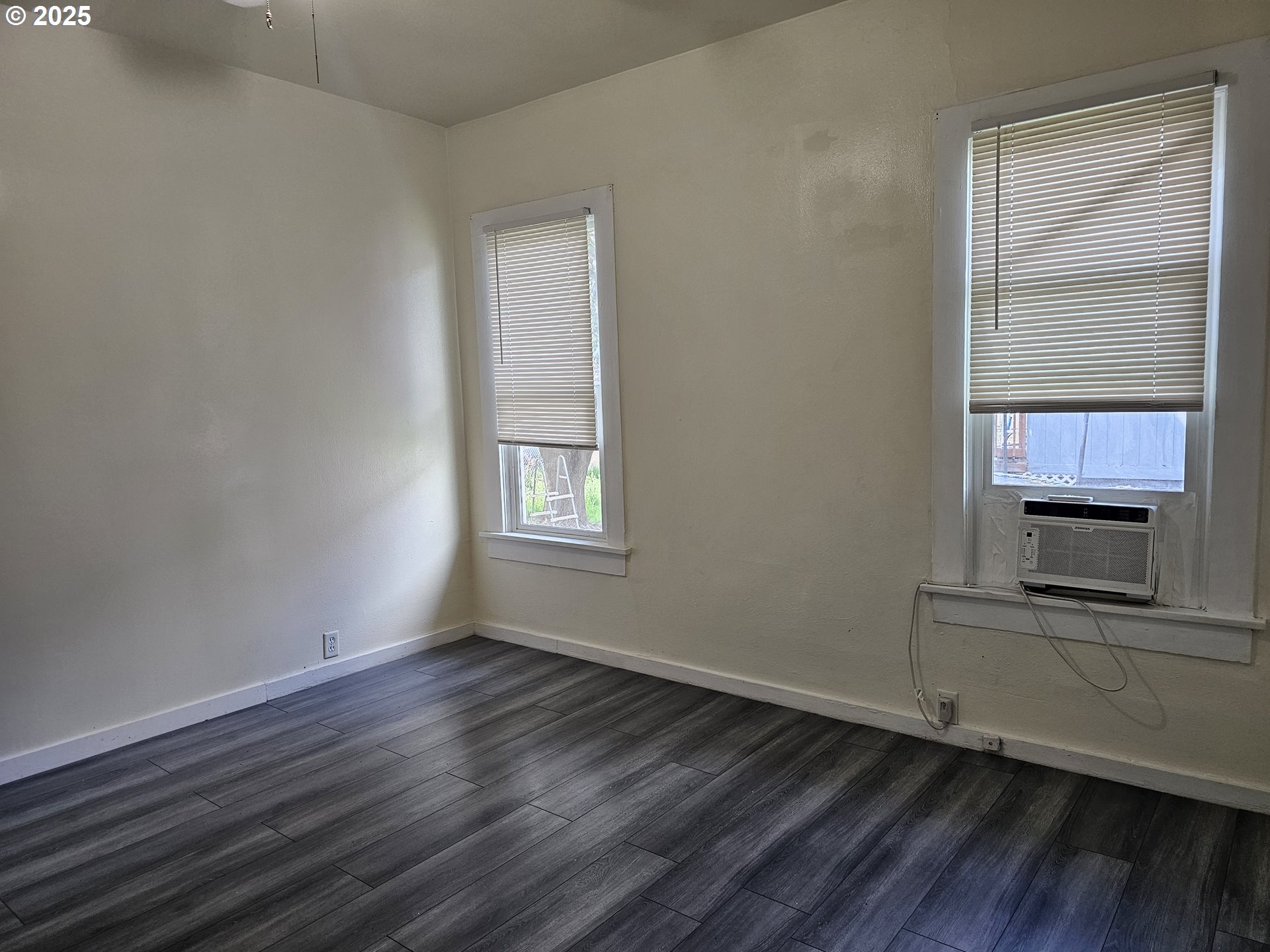617 Southwest 3rd Street Pendleton, OR 97801 - Photo 29 of 42 an empty room with wooden floor a ceiling fan and windows