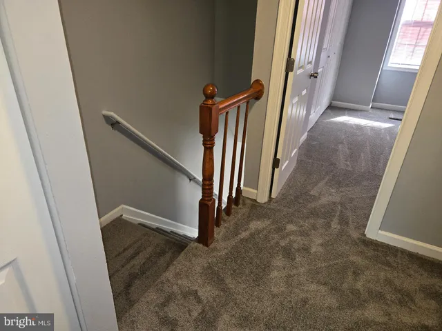 an entryway with stairs and a window