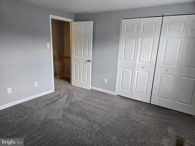 a view of an empty room with closet area