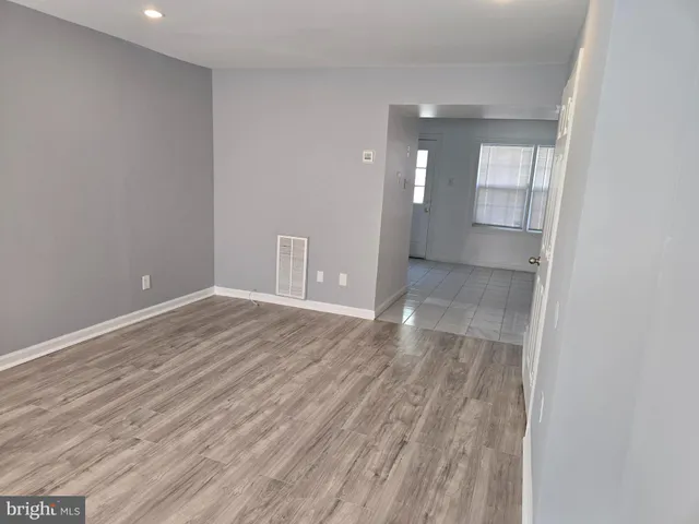 wooden floor in an empty room with a mirror