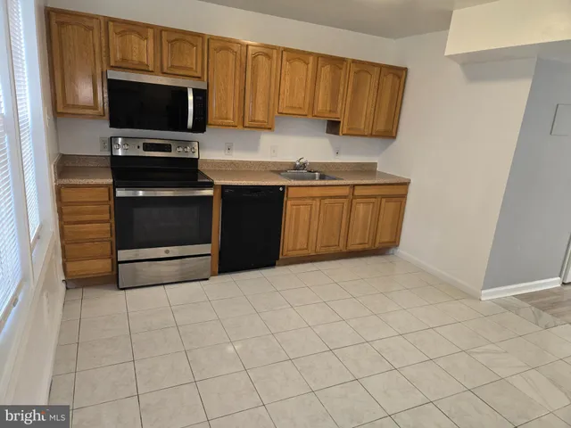 a kitchen with a sink and a stove top oven