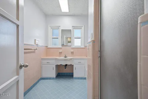 a spacious bathroom with a sink and a mirror