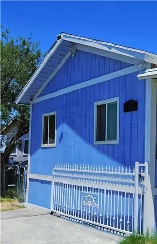 a front view of a house with plants