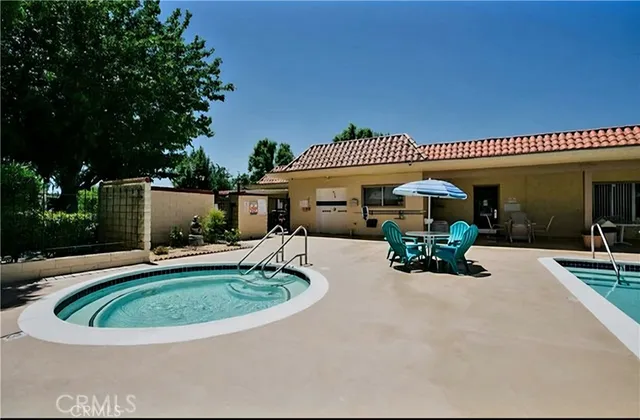 a view of a house with swimming pool and sitting area