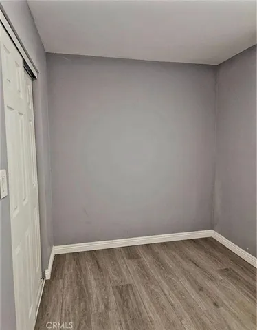 a view of an empty room and wooden floor