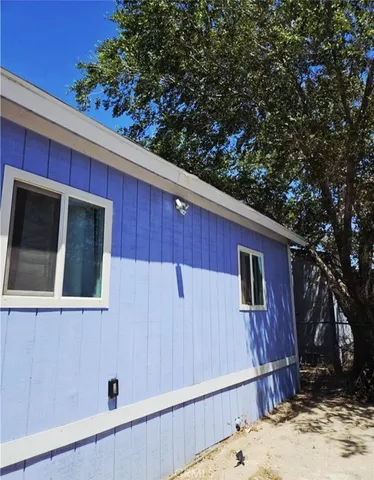 a view of a house with a tree