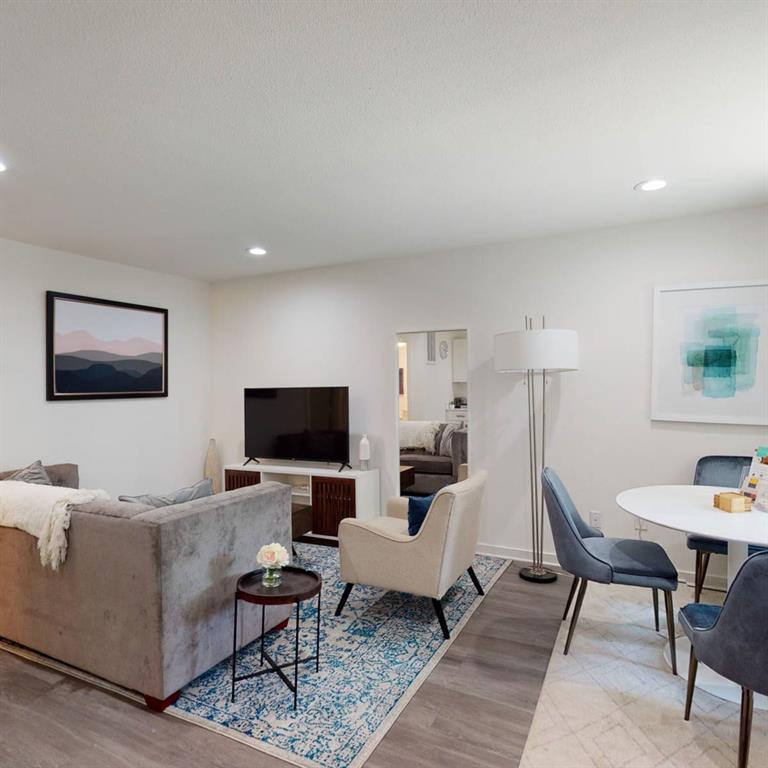 321 East 8th Street, Unit A2 Dallas, TX 75203 - Photo 11 of 14 a living room with furniture and a flat screen tv