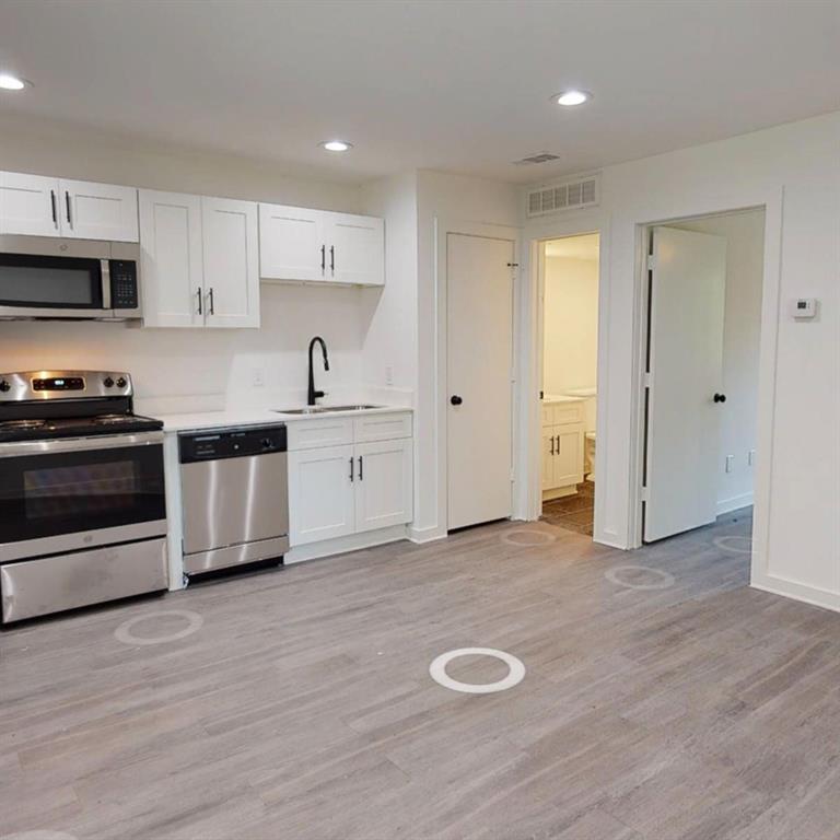 321 East 8th Street, Unit A2 Dallas, TX 75203 - Photo 14 of 14 a kitchen with stainless steel appliances granite countertop a stove a sink and a refrigerator