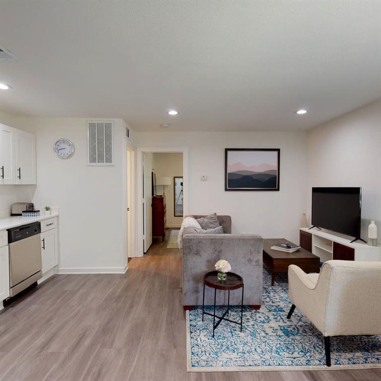 321 East 8th Street, Unit A2 Dallas, TX 75203 - Photo 2 of 14 a living room with furniture and a flat screen tv
