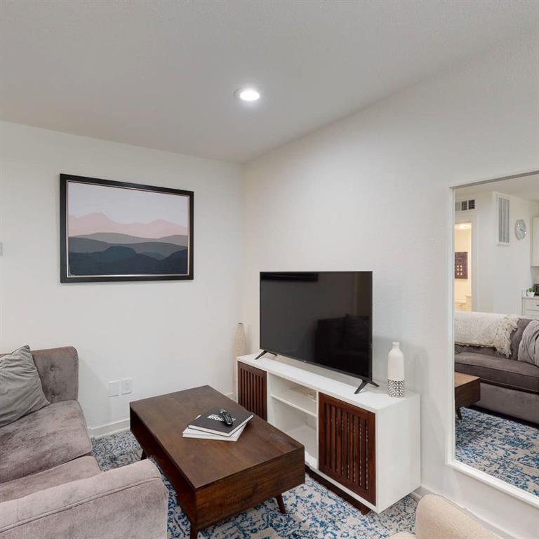321 East 8th Street, Unit A2 Dallas, TX 75203 - Photo 10 of 14 a living room with furniture and a flat screen tv