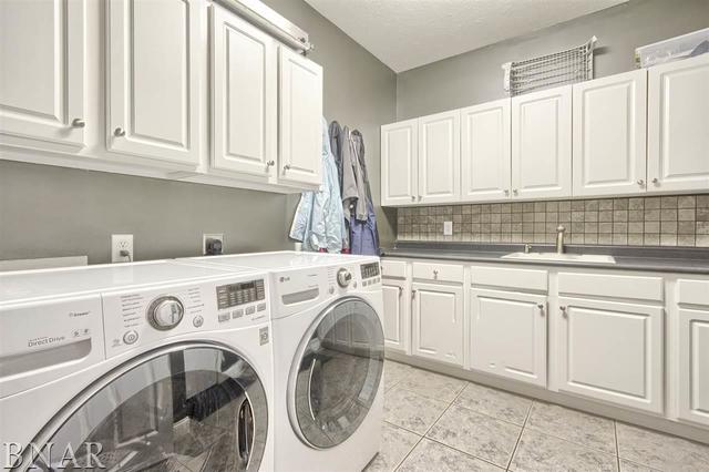 6762 Alexander Road Heyworth, IL 61745 - Photo 13 of 27 a view of kitchen with granite countertop a sink a washer and dryer next to a window