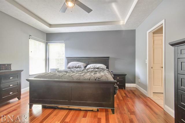 6762 Alexander Road Heyworth, IL 61745 - Photo 14 of 27 a bed sitting in a bedroom next to a window