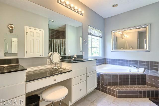 6762 Alexander Road Heyworth, IL 61745 - Photo 17 of 27 a bathroom with a sink double vanity and a bathtub