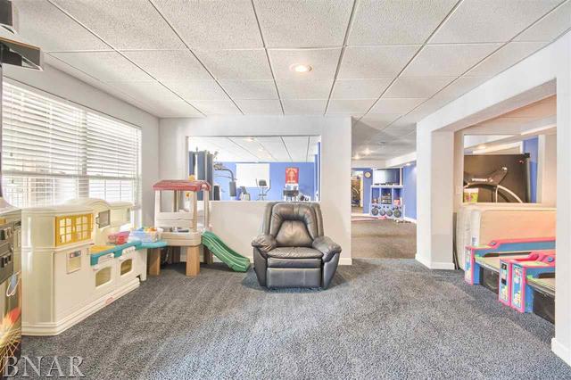 6762 Alexander Road Heyworth, IL 61745 - Photo 24 of 27 a living room with furniture and a flat screen tv