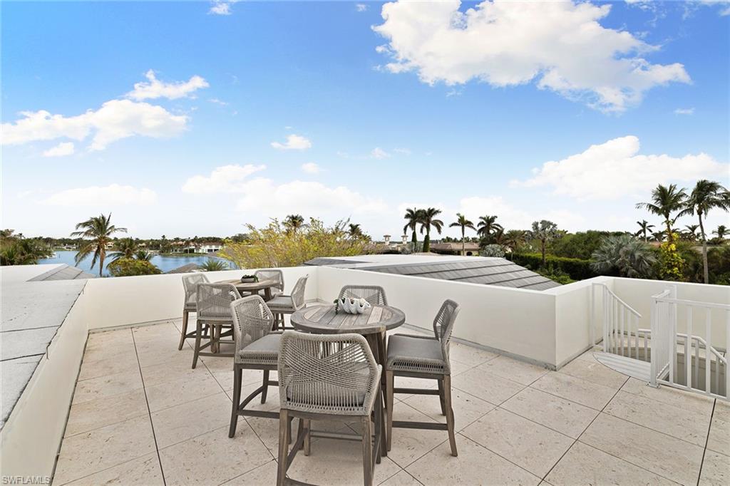 12 Sabre Lane Naples, FL 34102 - Photo 11 of 50 a terrace with outdoor seating and city view