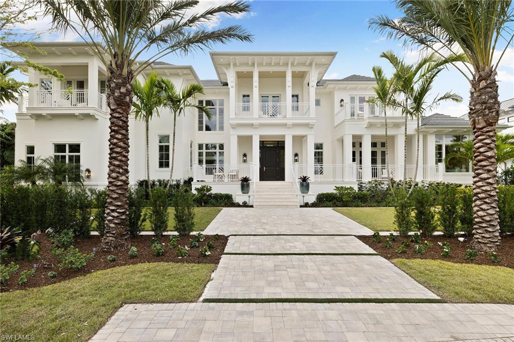 12 Sabre Lane Naples, FL 34102 - Photo 19 of 50 a front view of a house with a garden