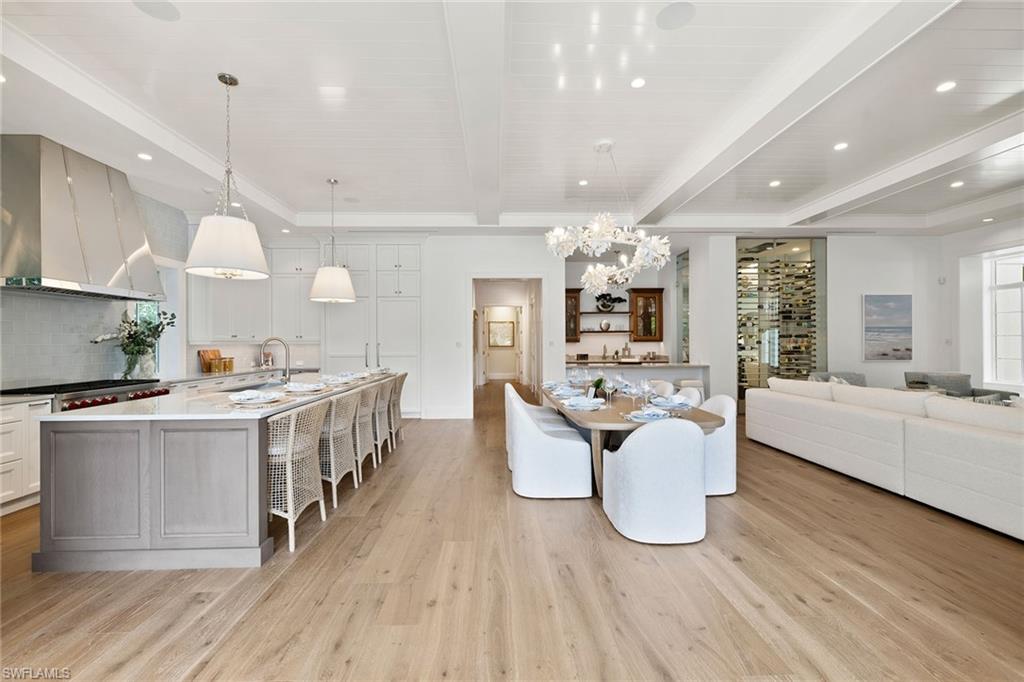 12 Sabre Lane Naples, FL 34102 - Photo 20 of 50 a large white kitchen with lots of counter space wooden floor and stainless steel appliances