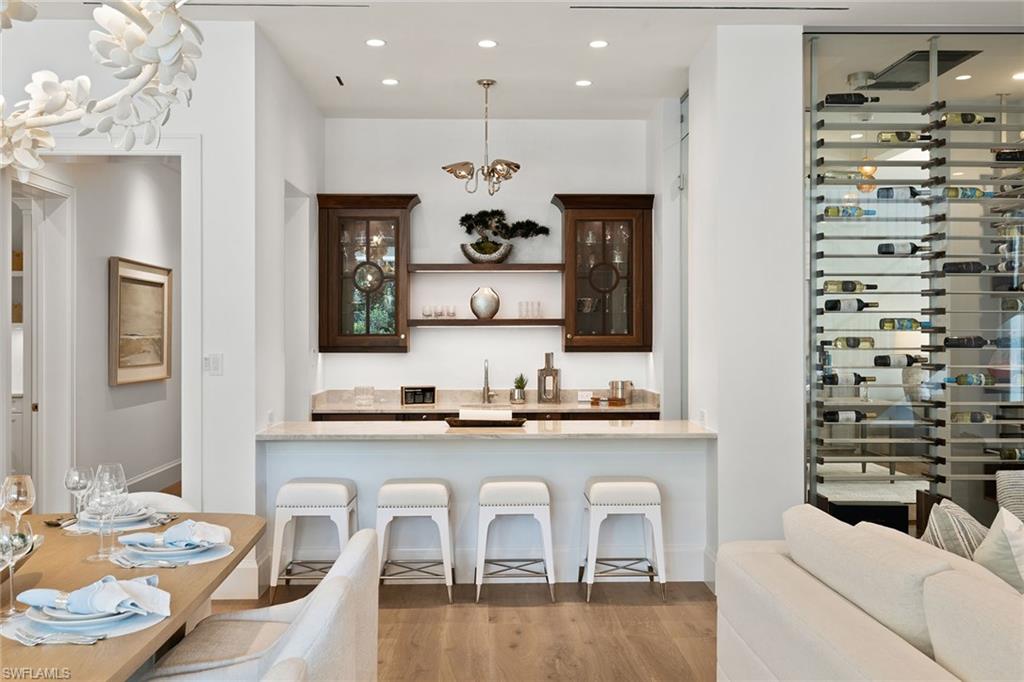 12 Sabre Lane Naples, FL 34102 - Photo 25 of 50 a kitchen with a sink and chairs