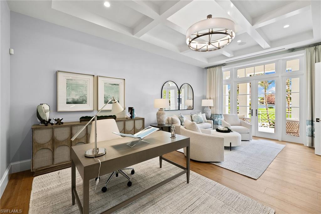 12 Sabre Lane Naples, FL 34102 - Photo 28 of 50 a living room with furniture a chandelier and a large window