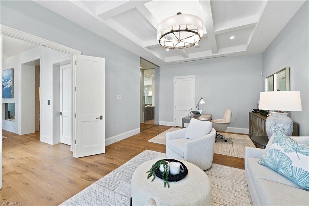 12 Sabre Lane Naples, FL 34102 - Photo 29 of 50 a living room with furniture and a chandelier
