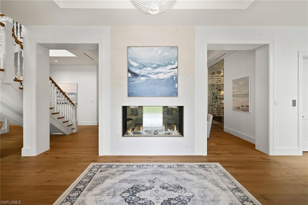 12 Sabre Lane Naples, FL 34102 - Photo 30 of 50 a view of a hallway with wooden floor and a living room