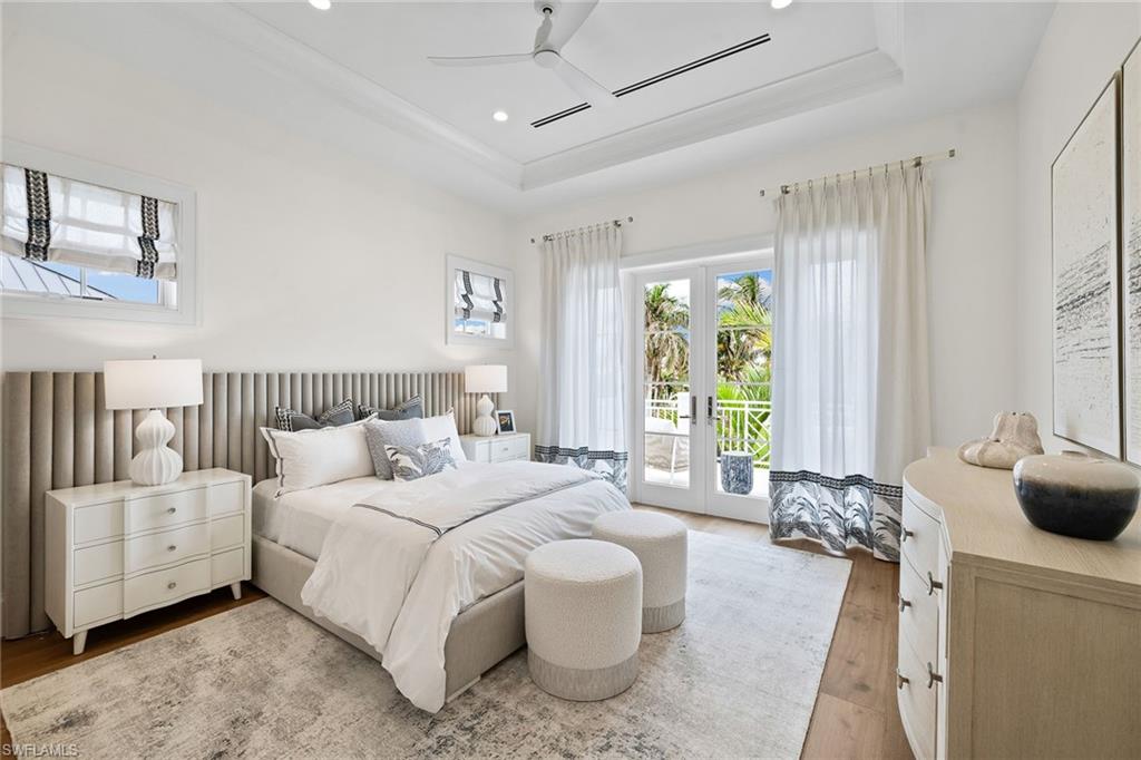 12 Sabre Lane Naples, FL 34102 - Photo 32 of 50 a spacious bedroom with a bed and a couch