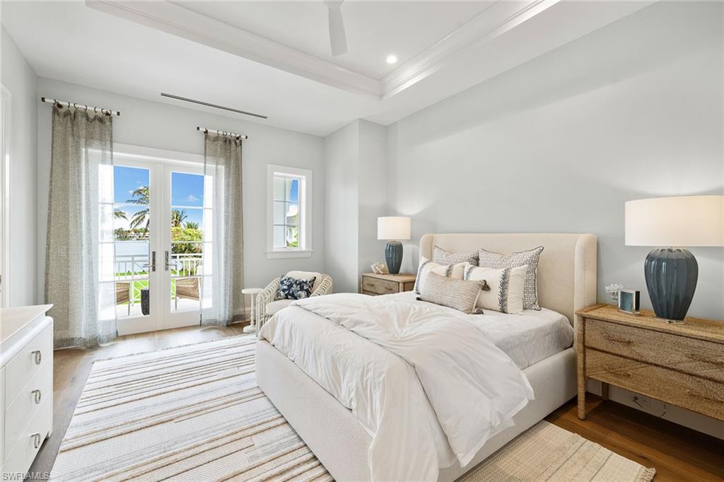 12 Sabre Lane Naples, FL 34102 - Photo 34 of 50 a spacious bedroom with a bed and a large window