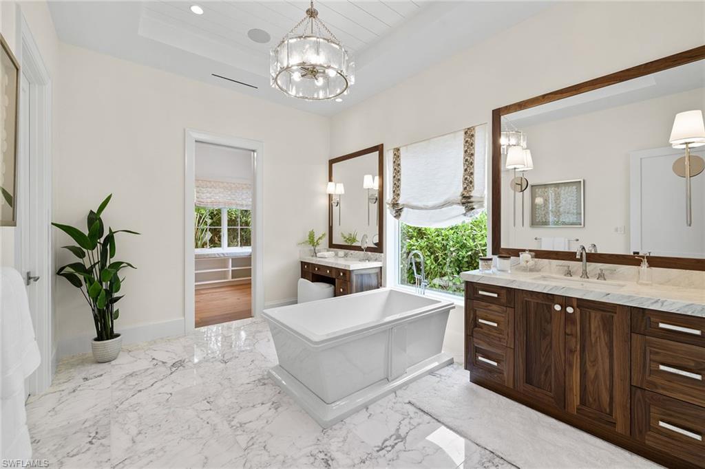 12 Sabre Lane Naples, FL 34102 - Photo 46 of 50 a large white kitchen with a chandelier