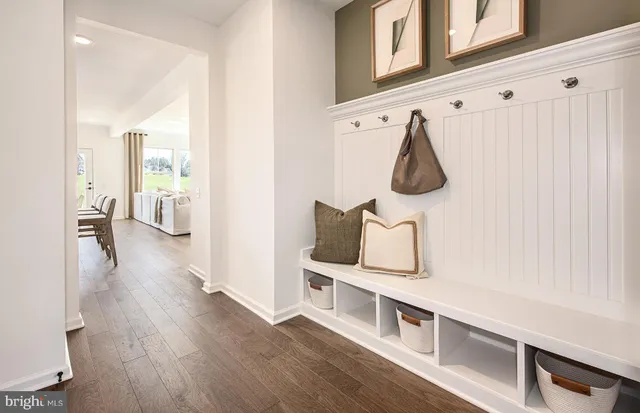 a hallway with hardwood floor and furniture
