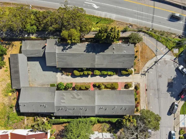 an aerial view of a house with a yard
