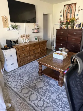 a living room with couches and flat screen tv