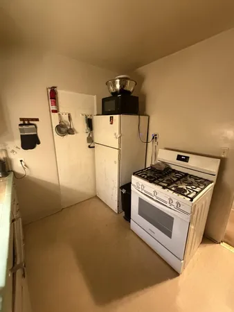 a kitchen with a stove and a refrigerator
