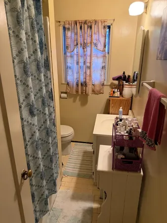 a bathroom with a toilet sink and shower