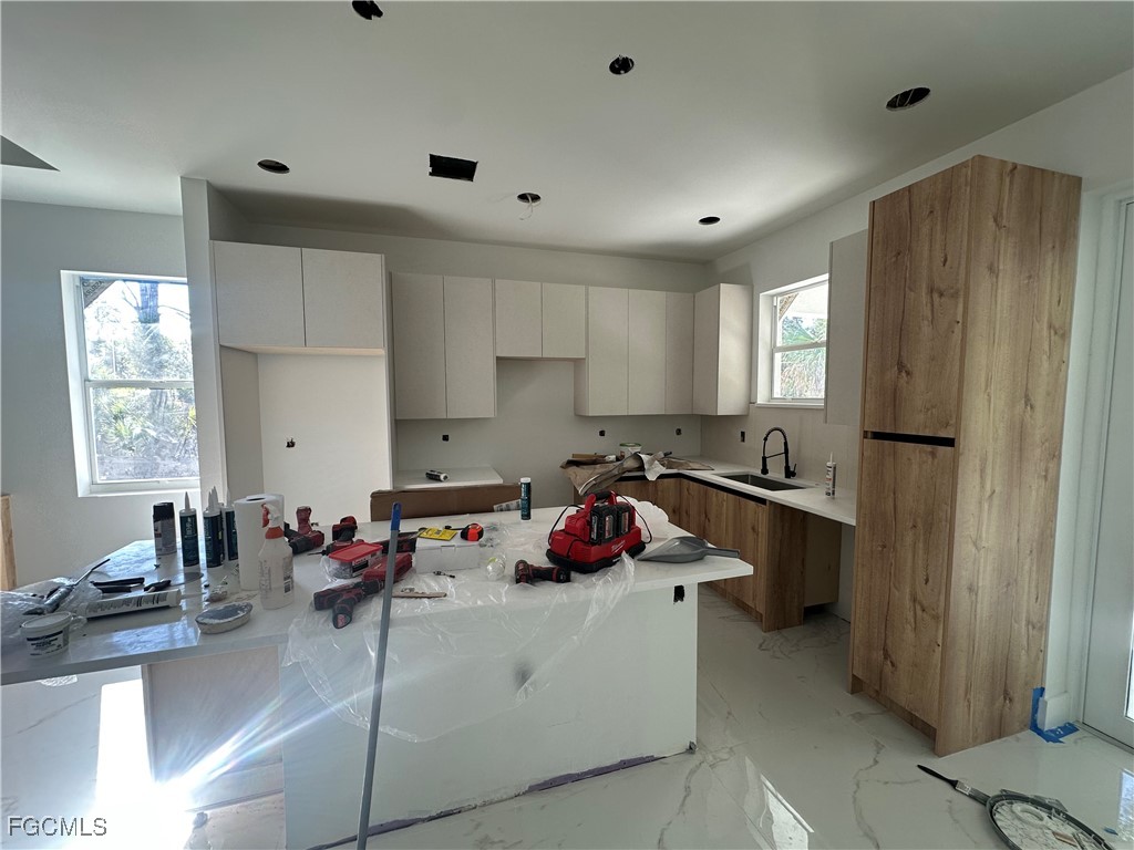 1073 Sherwin Street Port Charlotte, FL 33953 - Photo 6 of 14 a kitchen with a sink stove and refrigerator