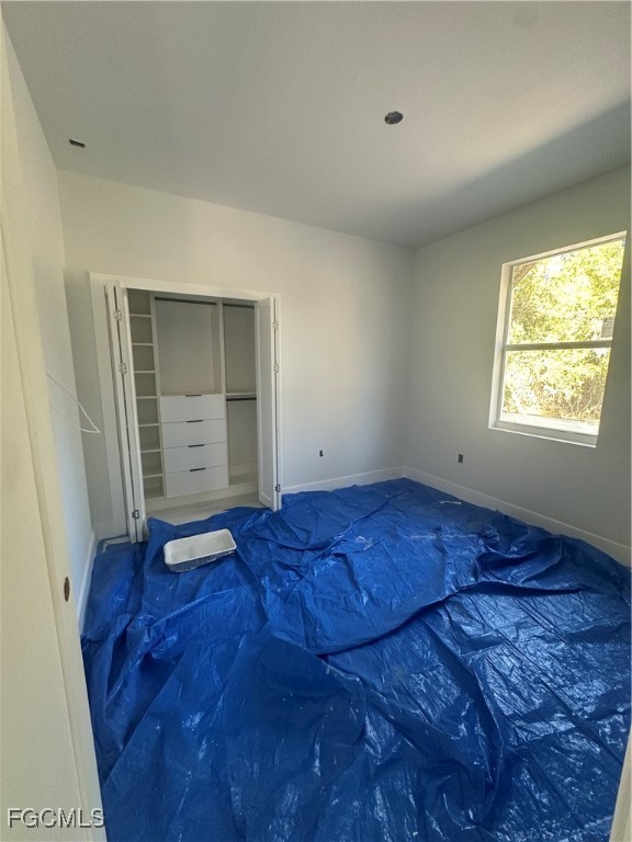 1073 Sherwin Street Port Charlotte, FL 33953 - Photo 9 of 14 a view of empty room with wooden floor and fan