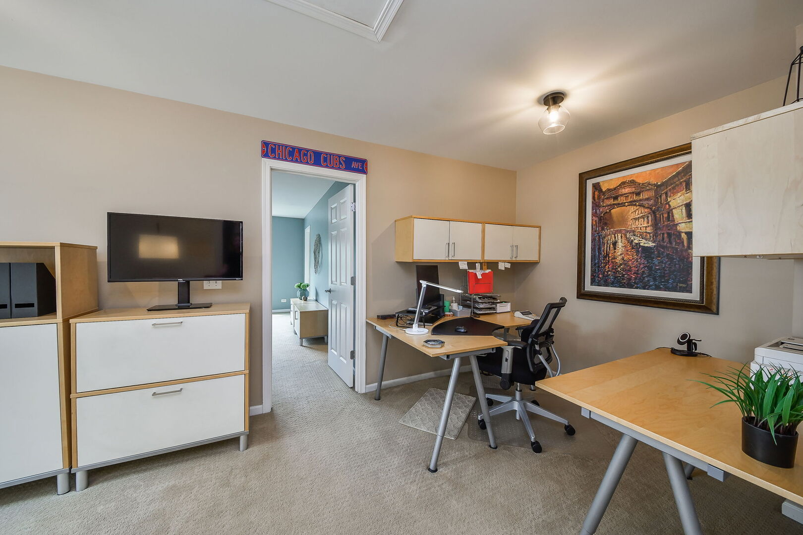 375 Ridge Road North Aurora, IL 60542 - Photo 18 of 24 a view of a workspace with furniture and a flat screen tv